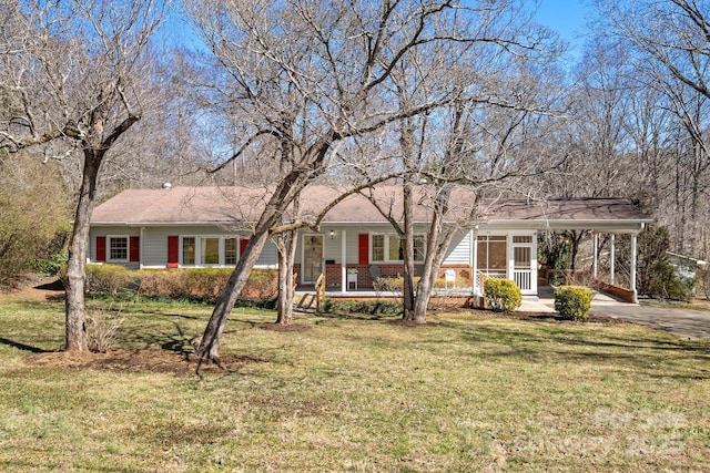 ranch-style house with a front yard, covered porch, brick siding, and driveway