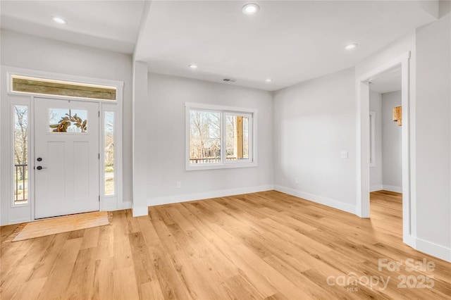 entryway with baseboards, visible vents, light wood-style flooring, and recessed lighting