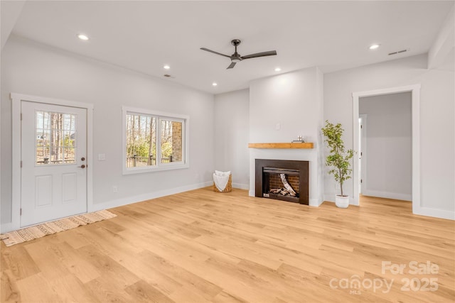 unfurnished living room featuring light wood finished floors, a fireplace, visible vents, and recessed lighting