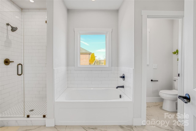 bathroom featuring a garden tub, toilet, baseboards, marble finish floor, and a stall shower