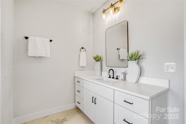 bathroom featuring marble finish floor, baseboards, and vanity