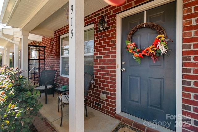 property entrance with brick siding