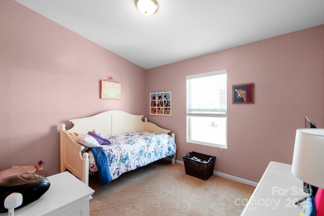 bedroom featuring light carpet and baseboards