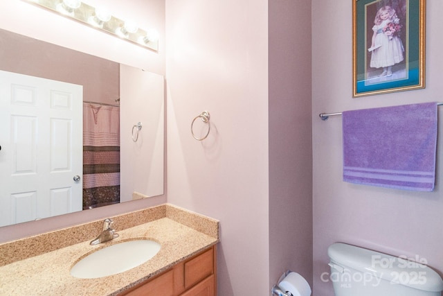 full bathroom with toilet and vanity