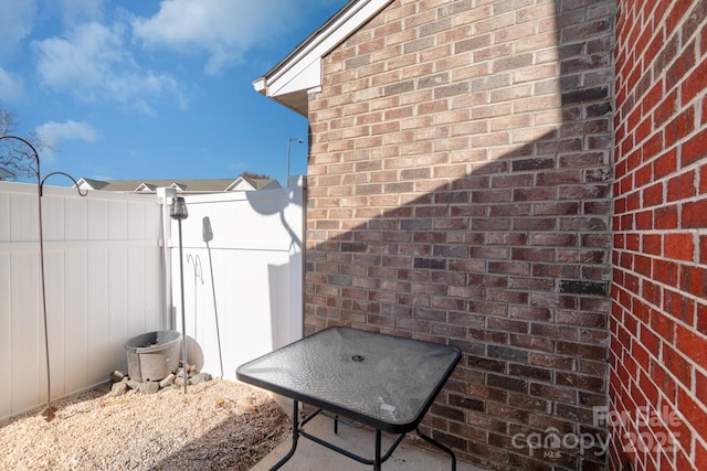 view of patio featuring fence