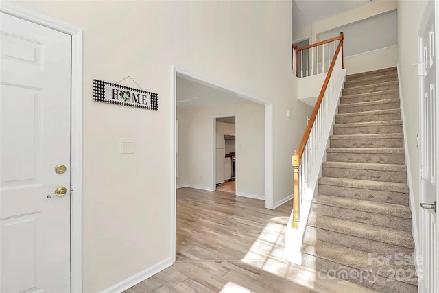 stairs featuring baseboards and wood finished floors