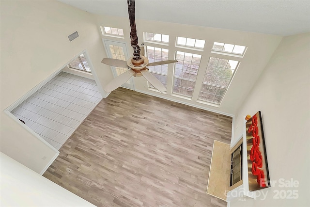 unfurnished living room with light wood finished floors and ceiling fan