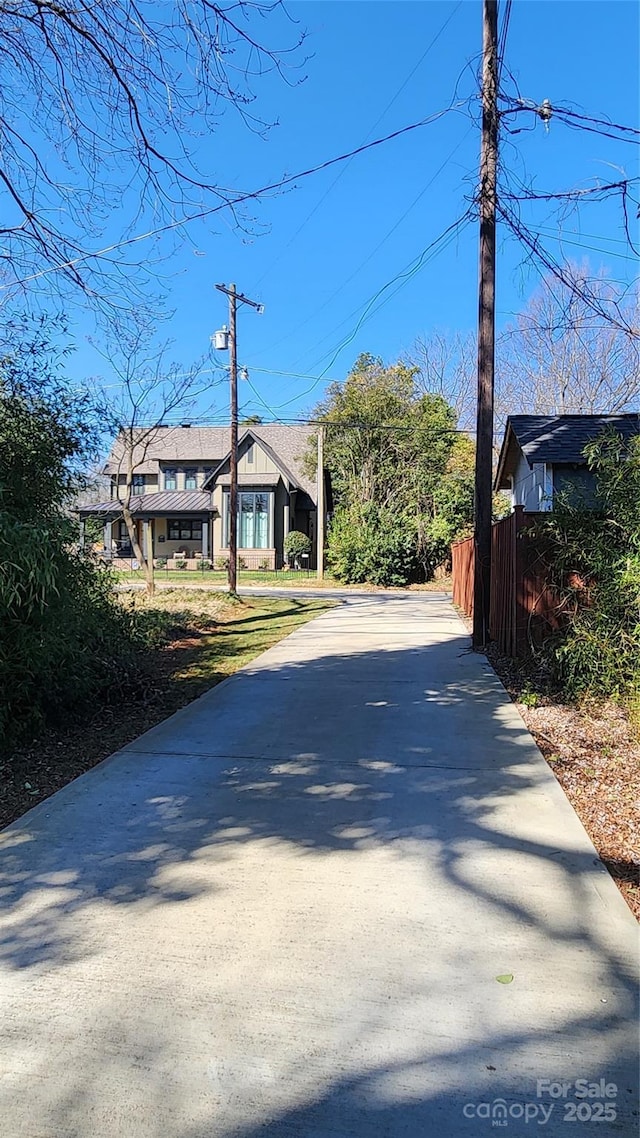 view of street featuring concrete driveway