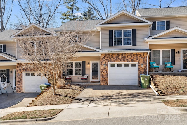 view of front facade with aphalt driveway, stone siding, a porch, and a garage