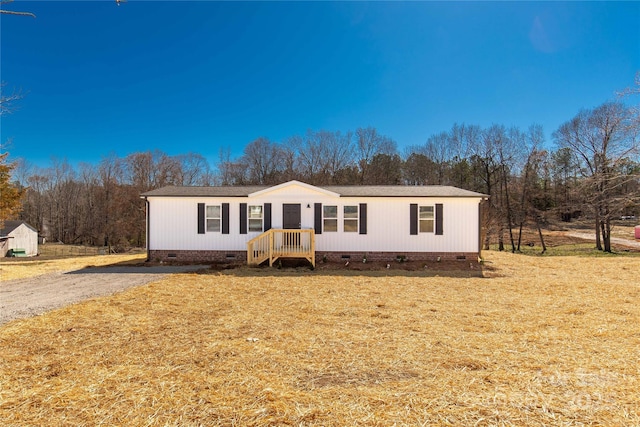 manufactured / mobile home featuring crawl space and a front lawn