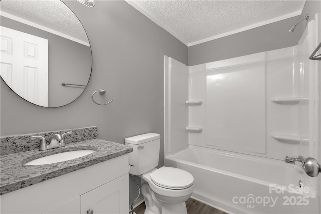 full bath with shower / tub combination, a textured ceiling, toilet, and vanity