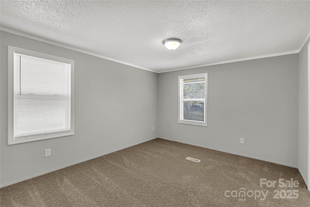 unfurnished room featuring a textured ceiling, carpet floors, visible vents, and crown molding