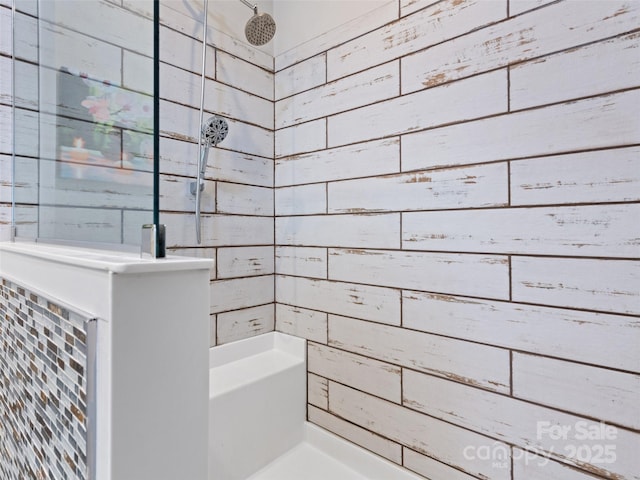 full bath featuring a tile shower