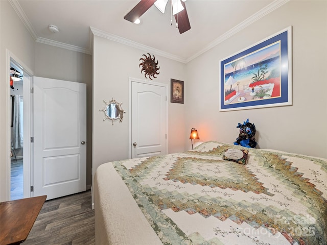 bedroom featuring ceiling fan, ornamental molding, and dark wood-type flooring