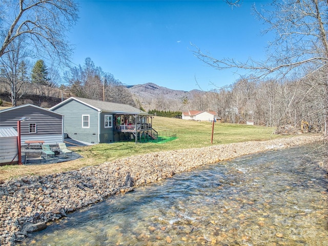 view of yard with a water and mountain view