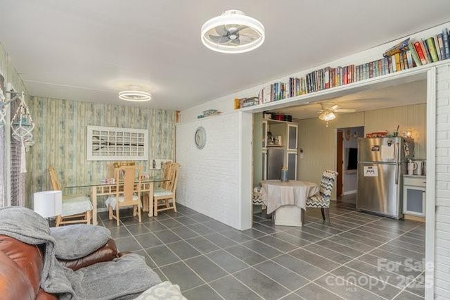 interior space featuring tile patterned flooring and ceiling fan