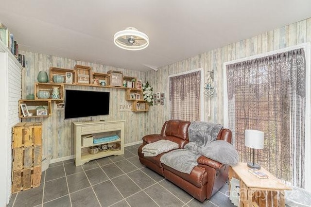 tiled living area with baseboards and wallpapered walls