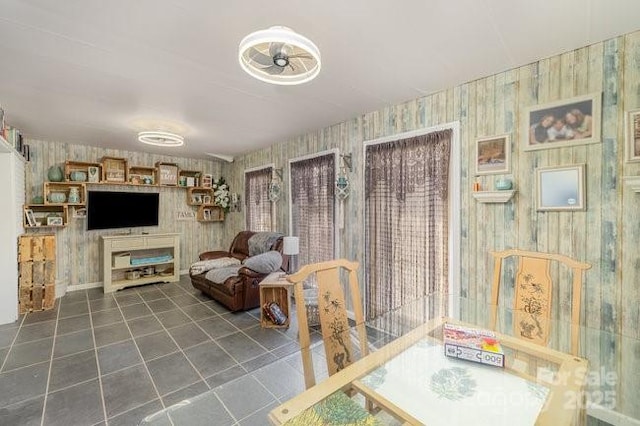 living room with wallpapered walls and tile patterned flooring