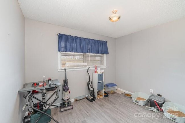 interior space featuring wood finished floors and baseboards