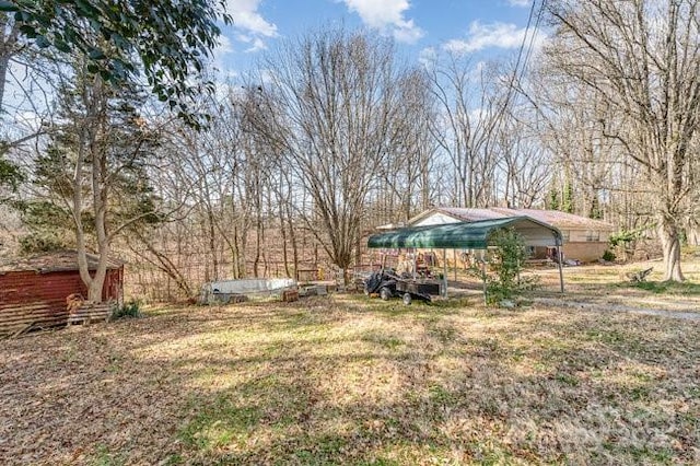 view of yard with an outbuilding and a carport