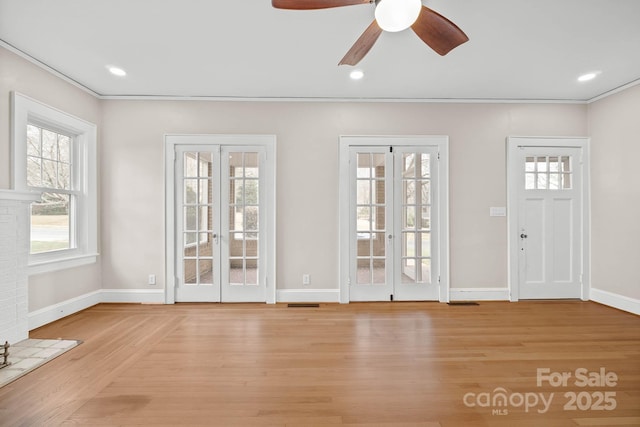 interior space with baseboards, french doors, recessed lighting, and light wood-style floors