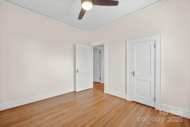 unfurnished bedroom featuring a ceiling fan, baseboards, and hardwood / wood-style floors