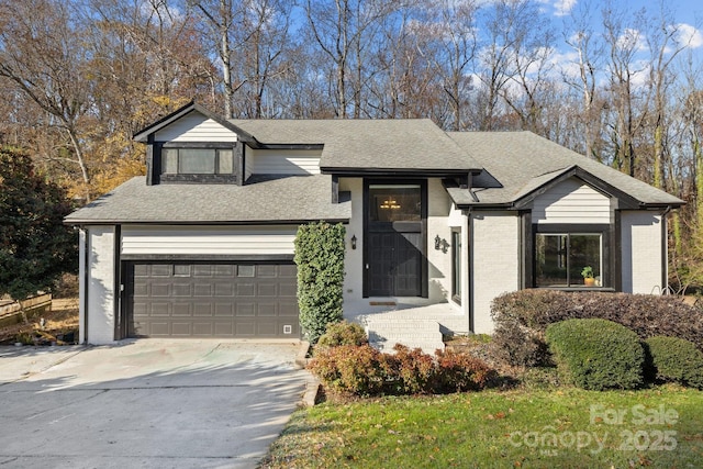 view of front of home featuring driveway, brick siding, an attached garage, and a shingled roof