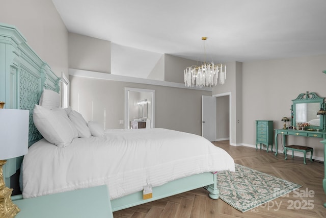 bedroom featuring a chandelier, vaulted ceiling, and connected bathroom