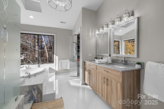 full bath featuring a garden tub, a sink, visible vents, and double vanity