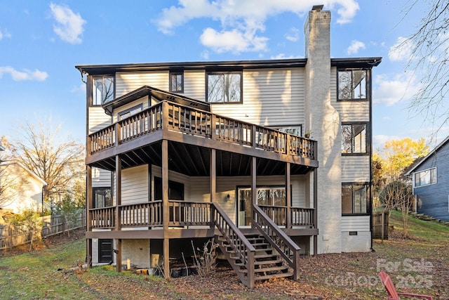 back of house featuring crawl space, a chimney, and a wooden deck