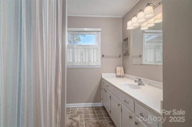 bathroom featuring baseboards, visible vents, ornamental molding, a textured ceiling, and vanity