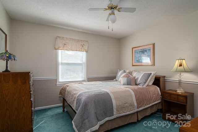 bedroom with a textured ceiling, ceiling fan, dark carpet, and baseboards