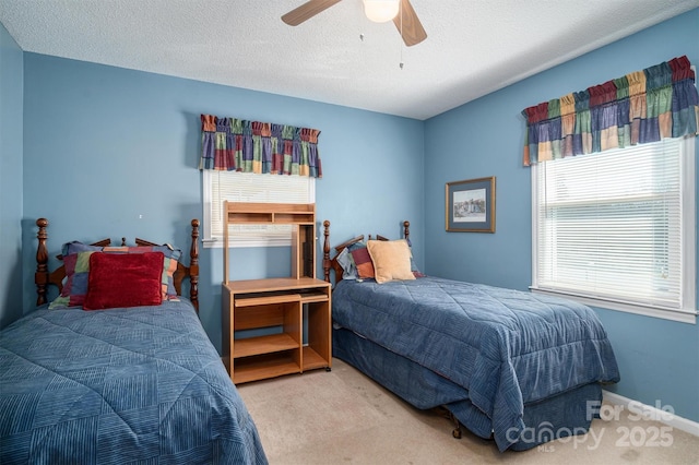 carpeted bedroom featuring ceiling fan, baseboards, and a textured ceiling