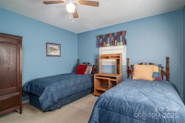 bedroom with light colored carpet, ceiling fan, and a textured ceiling