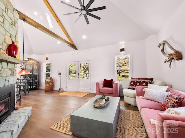 living room featuring high vaulted ceiling, wood finished floors, a ceiling fan, french doors, and beam ceiling