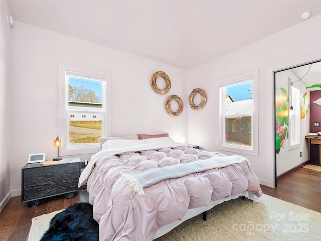 bedroom featuring dark wood finished floors and baseboards