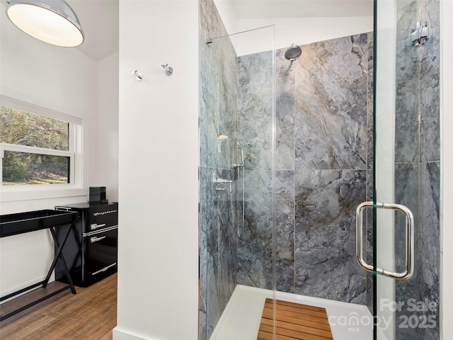 bathroom featuring a shower stall and wood finished floors