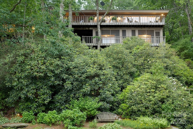 rear view of property featuring a balcony