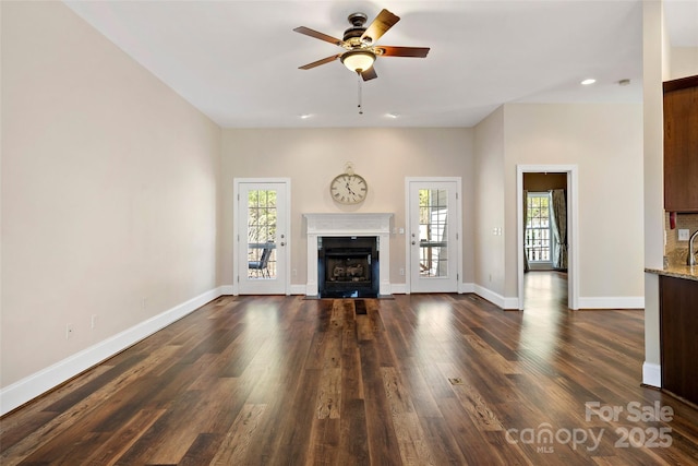 941 Wash Freeman Rd, Hendersonville, NC 28792 - unfurnished living room with healthy amount of natural light, ceiling fan, a fireplace with flush hearth, dark wood-style flooring, and recessed lighting