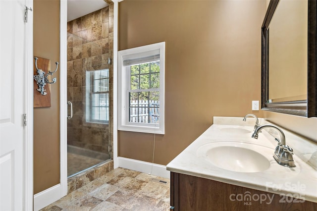 941 Wash Freeman Rd, Hendersonville, NC 28792 - bathroom featuring baseboards, a shower stall, double vanity, and stone finish floors