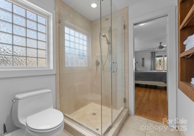 ensuite bathroom with toilet, a shower stall, ensuite bath, and a ceiling fan