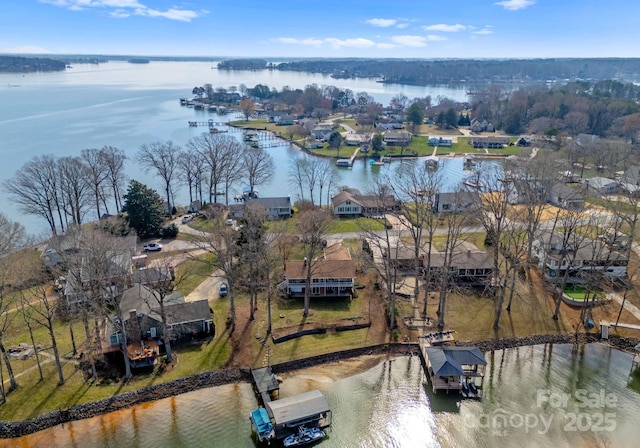 drone / aerial view featuring a water view and a residential view