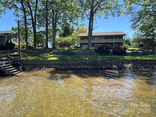 exterior space featuring a water view and stairs