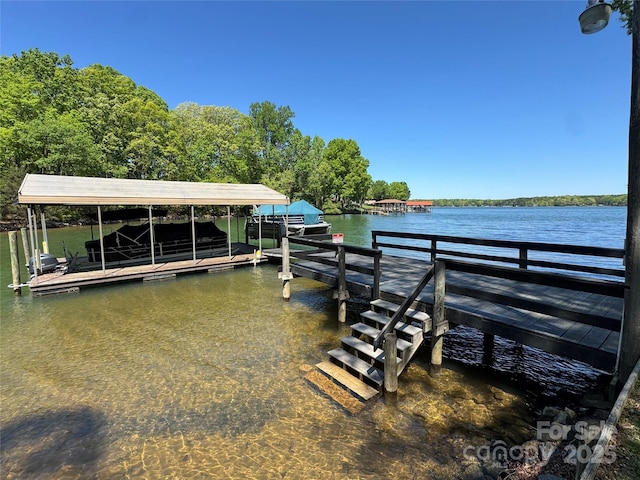 view of dock with boat lift and a water view