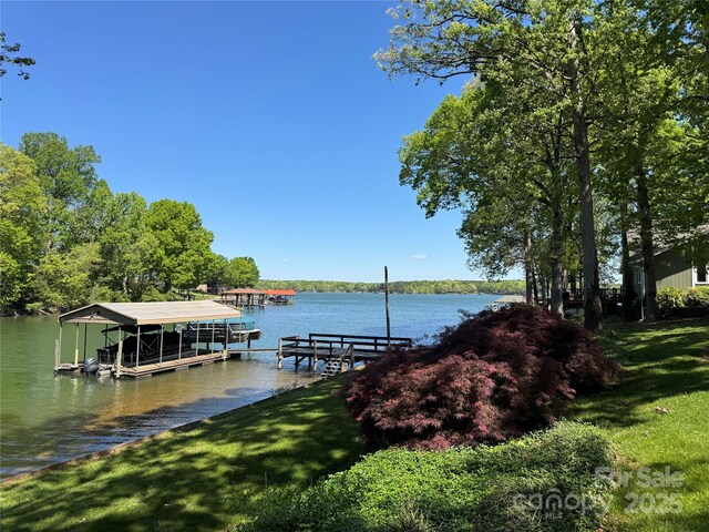 dock area featuring a water view and a yard
