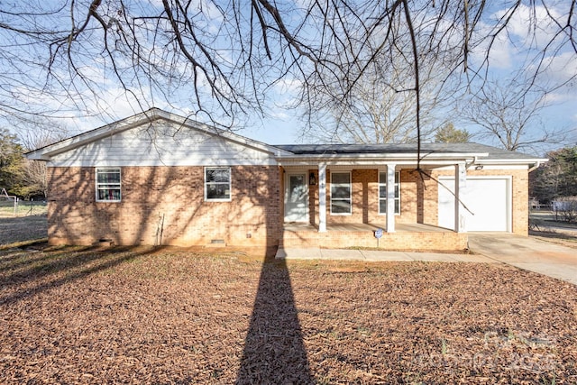 ranch-style home featuring an attached garage, covered porch, brick siding, driveway, and crawl space