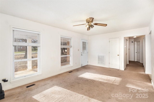 spare room with carpet and visible vents