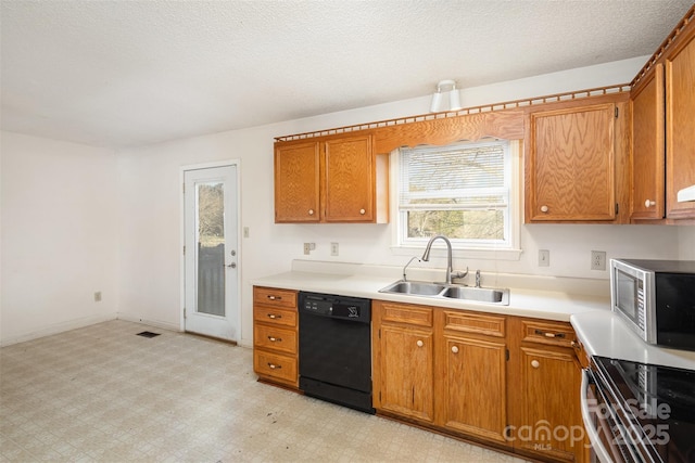 kitchen featuring light floors, stainless steel microwave, electric range, a sink, and dishwasher