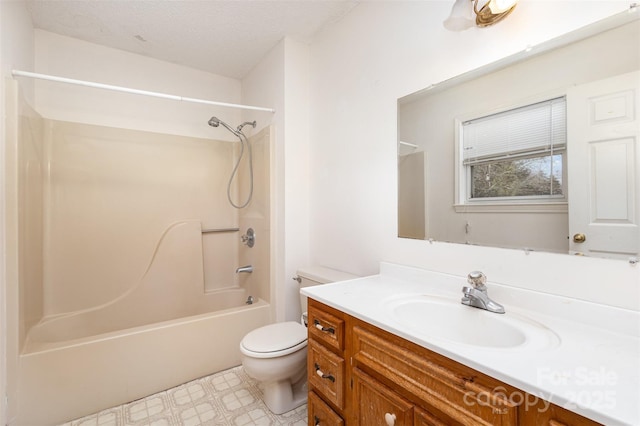 bathroom with bathing tub / shower combination, vanity, toilet, and a textured ceiling