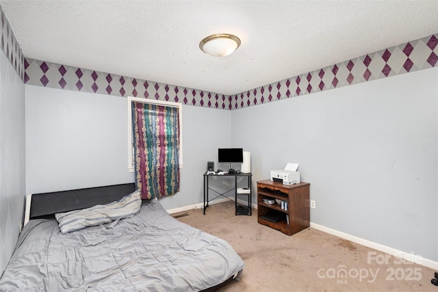 bedroom with a textured ceiling, baseboards, and carpet flooring